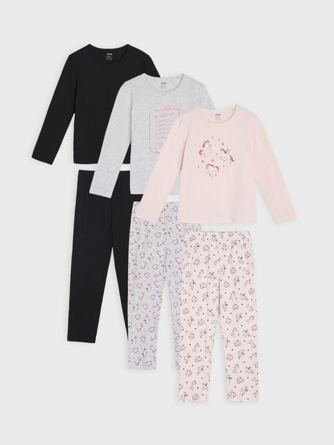Set of children's pajamas including a black top, gray top, pink top, and floral pants on a white background.