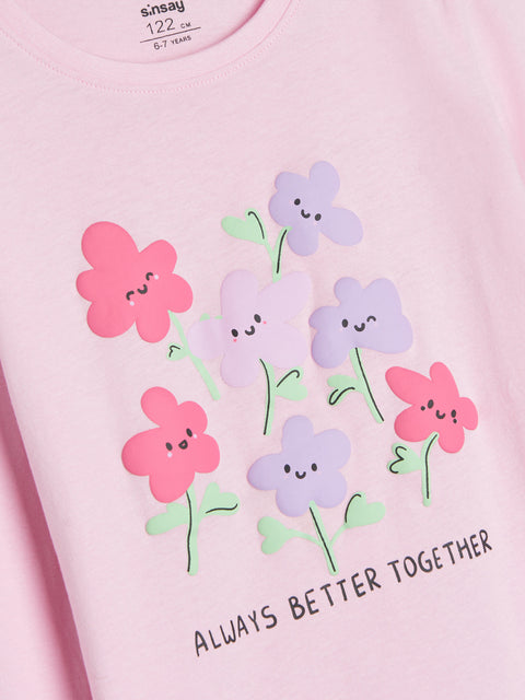 Pink shirt with cartoon flowers and 'Always Better Together' text on a pink background