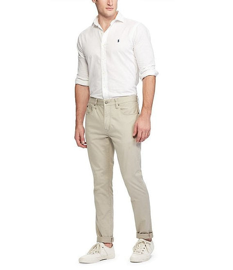 Man wearing a white shirt and beige pants on a white background