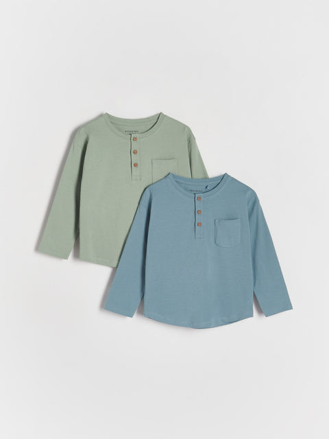 Two long-sleeve shirts, one green and one blue, on a white background.