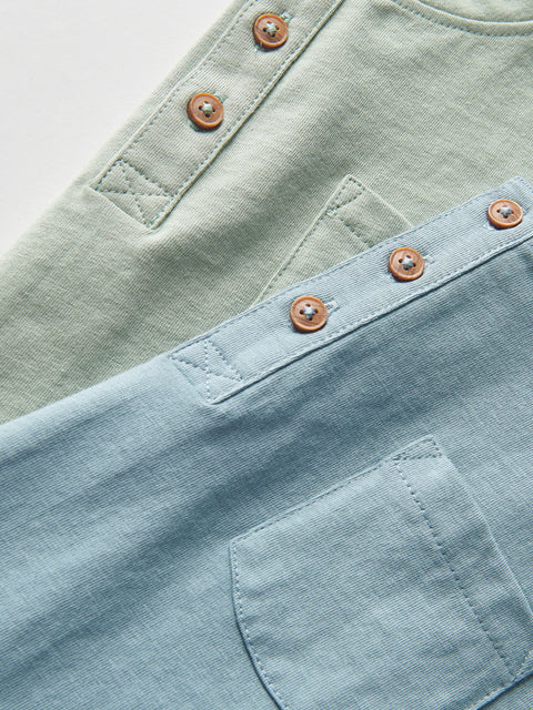 Close-up of light blue and green fabric with button details