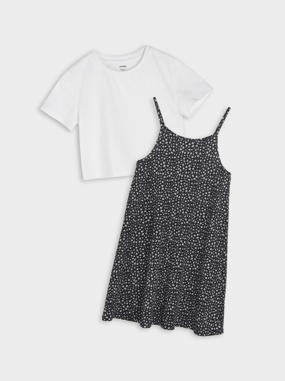 White t-shirt and black floral dress on a white background