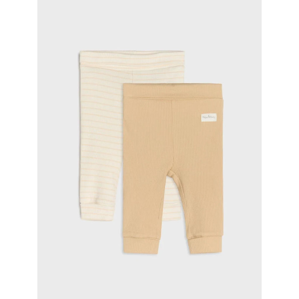 Two pairs of baby leggings laid flat on a light gray background. The front pair is a warm beige ribbed knit, and the back pair is cream with thin horizontal stripes.