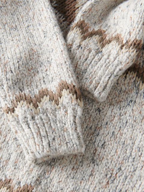 Close-up of a textured fabric with brown and beige pattern