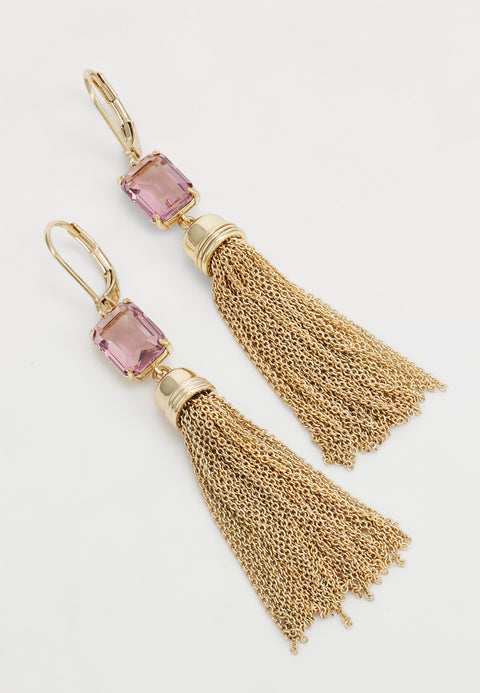 Gold tassel earrings with pink gemstones on a white background