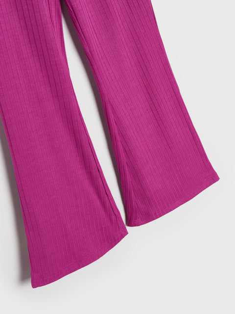 Close-up of bright pink ribbed pants on a white background