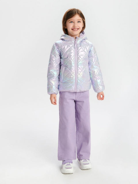 Child wearing a iridescent jacket and lavender pants on a white background