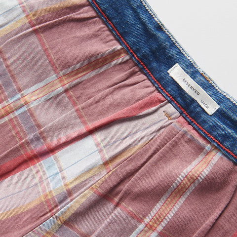 Close-up of a plaid fabric with a brand label visible