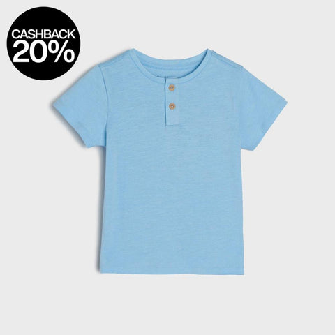 Light blue t-shirt with buttons on a light gray background