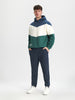 Person wearing a three-tone hoodie and pants on a white background