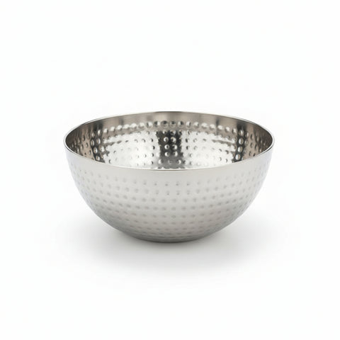 Metallic bowl with textured surface on a wooden surface