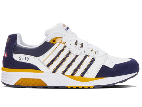 Navy and white sneaker with yellow accents on a white background
