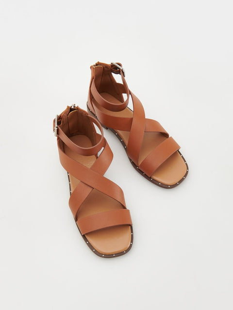 Pair of brown sandals on a white background