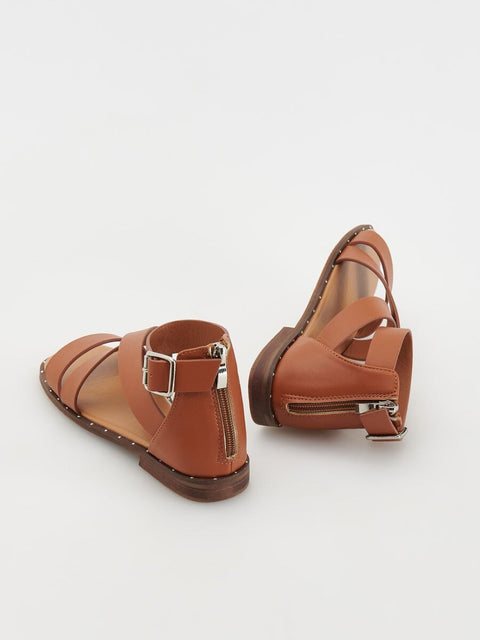 Pair of brown sandals with a buckle on a white background