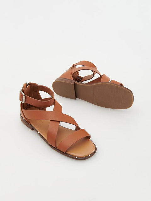 Pair of brown sandals on a white background