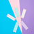 Five reusable menstrual cups in pastel colors, including light blue, lavender, mint, and white, arranged in a radial pattern on a split pink and purple background.
