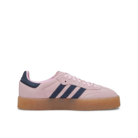Pink Adidas sneaker with three black stripes on a white background