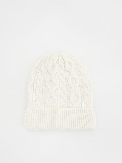 White knit beanie on a light gray background