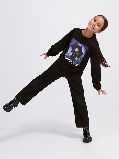 Person wearing a black sweatshirt with a graphic design on a white background