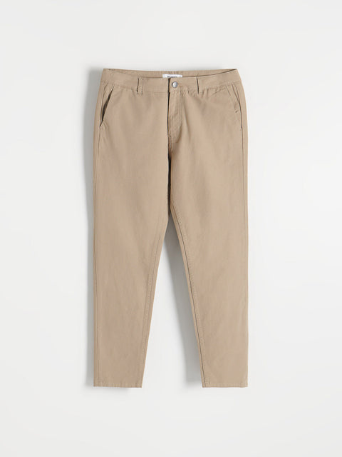 Beige pants on a light gray background