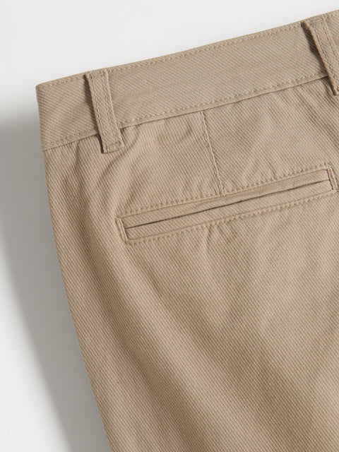 Close-up of beige pants with a pocket on a light gray background