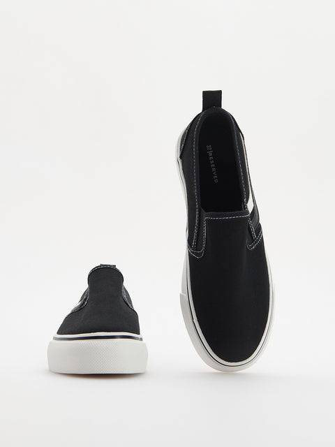 Black slip-on sneakers on a white background