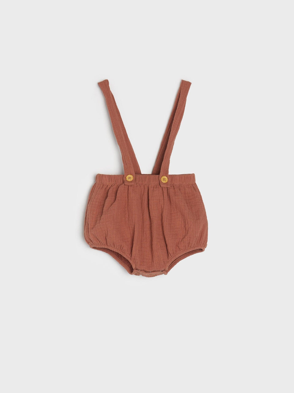 Brown baby bloomers with suspenders on a light gray background