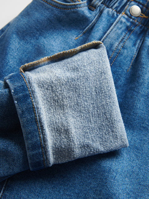 Close-up of blue denim fabric with a pocket detail