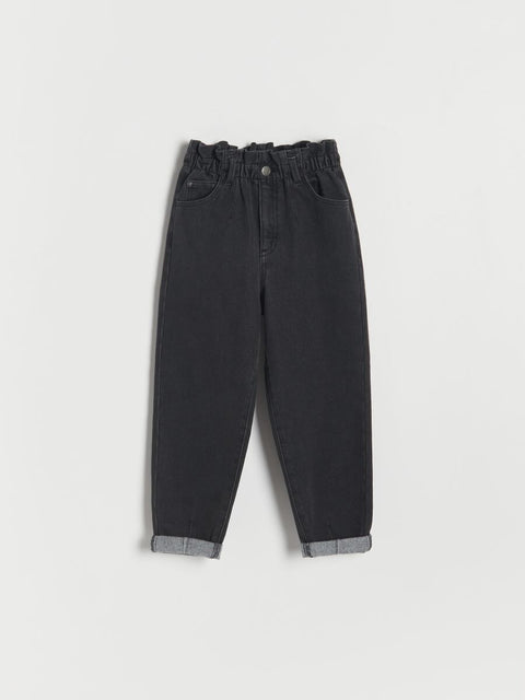 Black pants with rolled-up cuffs on a white background