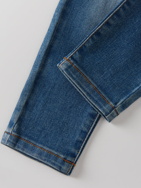 Close-up of blue jeans on a light gray background