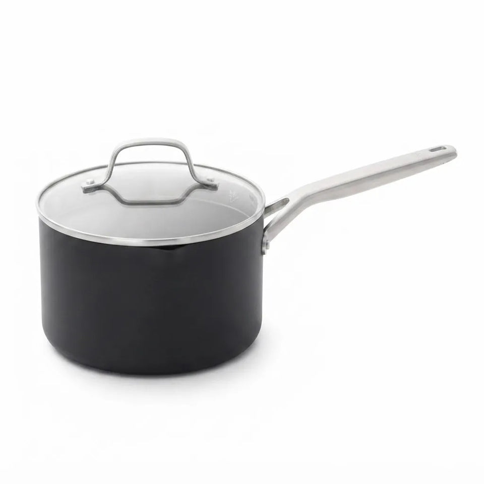 A black saucepan with a clear glass lid and a silver metal handle, shown on a plain white background.