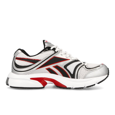 White sneaker with black and red accents on a white background
