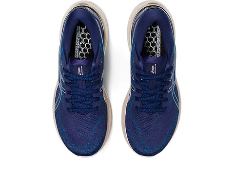 Pair of blue running shoes with white soles on a white background