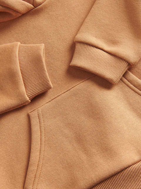 Close-up of a brown jacket with focus on sleeve and waistband
