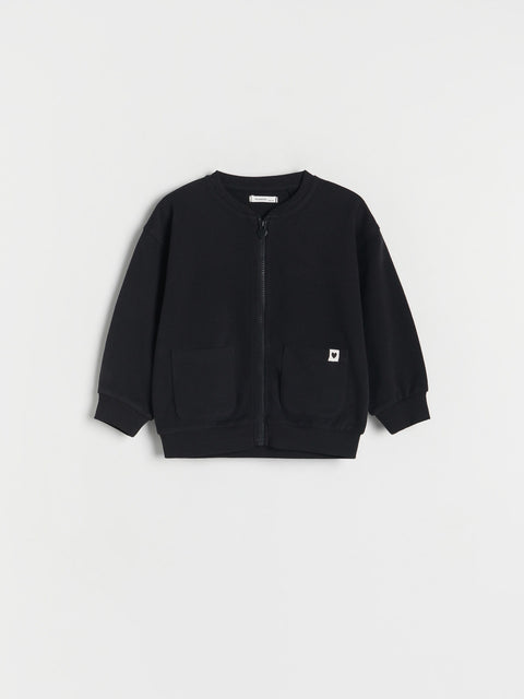 Black jacket with a small white logo on a light gray background