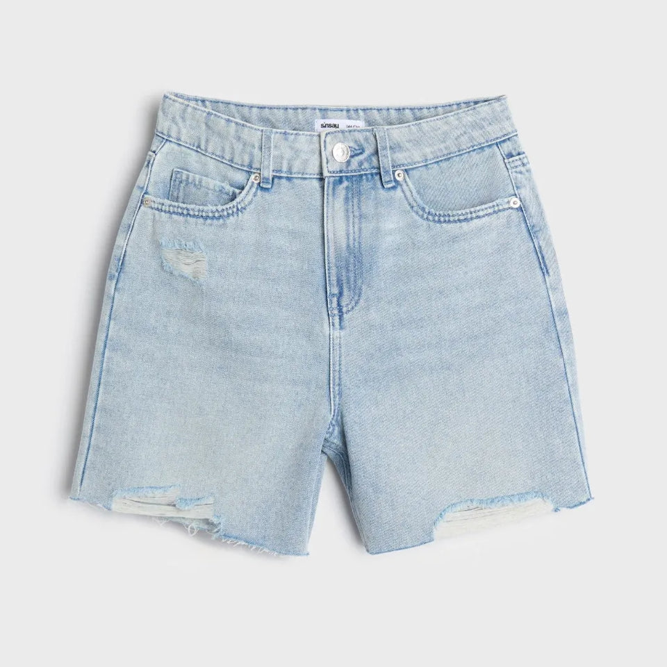 Light wash blue denim shorts with a distressed, frayed hem and a small rip on the left thigh, shown flat on a light gray background.