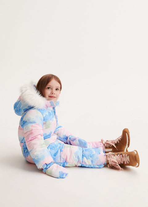 Child wearing a colorful snowsuit with fur-lined hood on a white background
