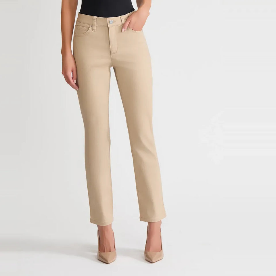A model wearing beige straight-leg jeans with a black top and beige high heels, shown from the waist down against a light gray studio background.