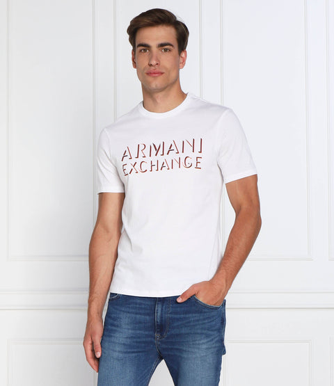 Man wearing a white Armani Exchange t-shirt against a white background