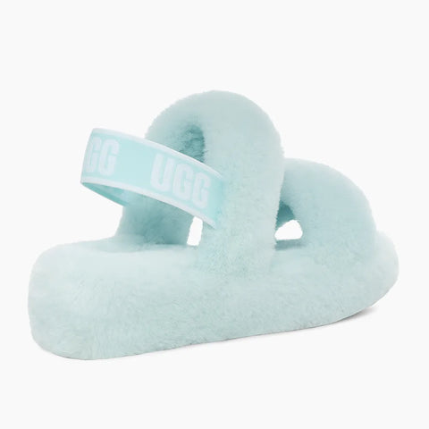Light blue fuzzy sandal with a white strap on a white background