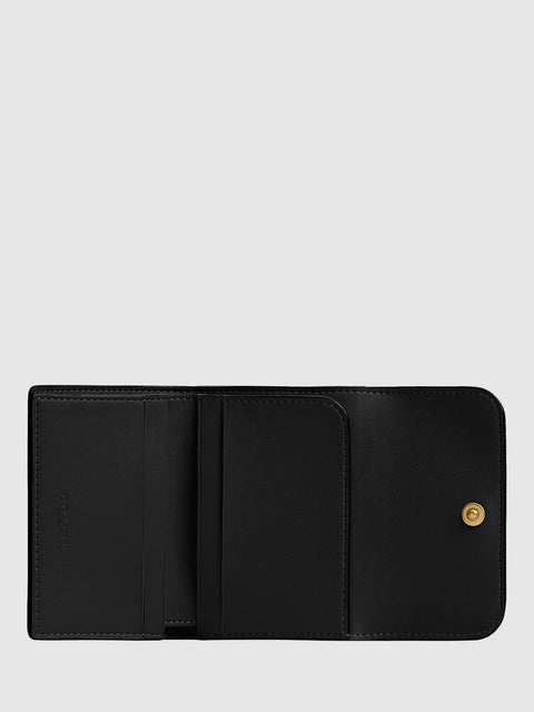Black leather wallet with a gold button on a light gray background