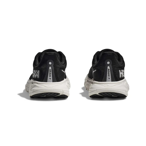 Black running shoes with white soles on a white background