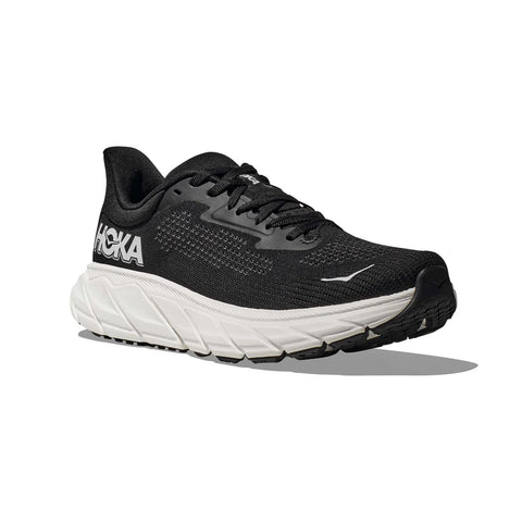 Black running shoe with white sole on a white background