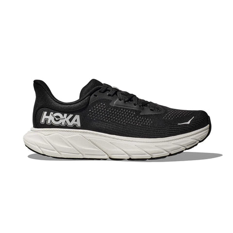 Black running shoe with white sole on a white background