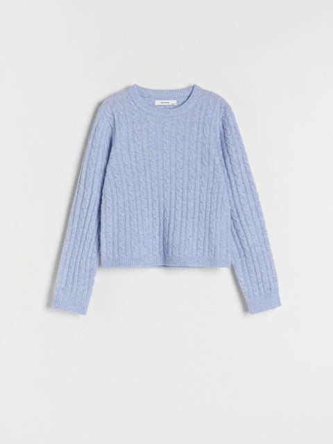Light blue ribbed sweater on a light gray background