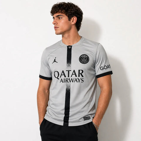 Person wearing a sports jersey with visible branding on a plain background