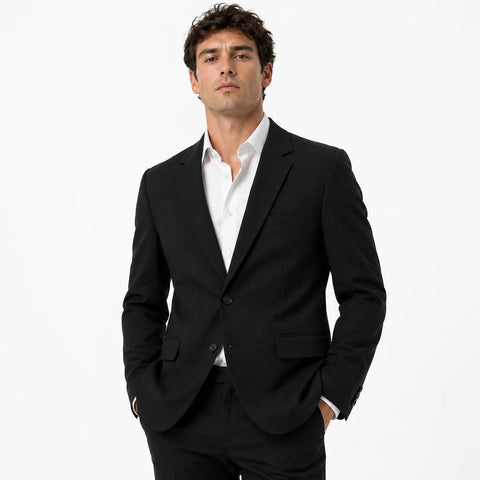 Man wearing a black suit and white shirt on a white background