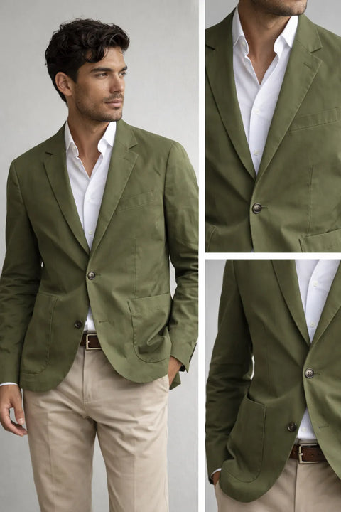 Man wearing a green blazer over a white shirt with beige pants on a light gray background.