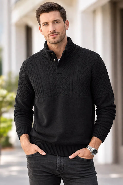 Man wearing a black cable knit sweater with a blurred background