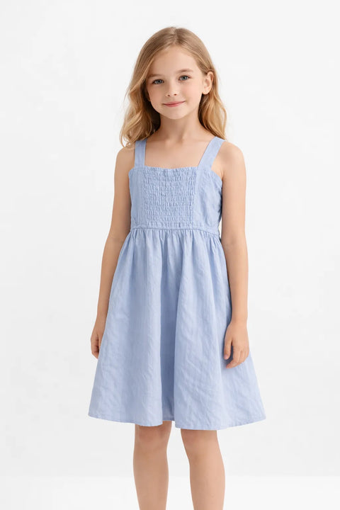 Young girl wearing a light blue dress on a white background
